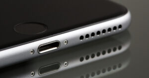The bottom of an Apple iPhone with an exposed Lightning connector port.