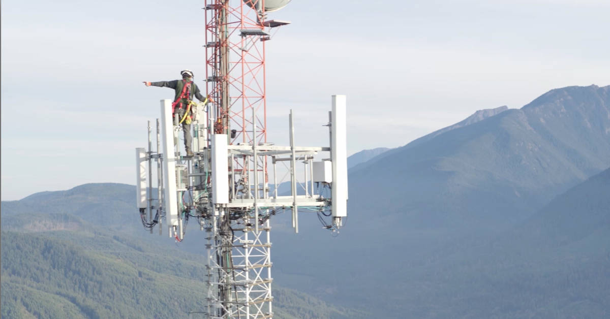 An engineer climbs a wireless network tower.