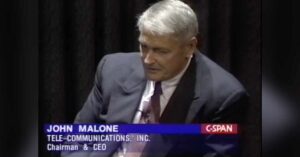 Former TCI Chairman and Chief Executive Officer John Malone appears during a discussion panel on November 26, 1998.