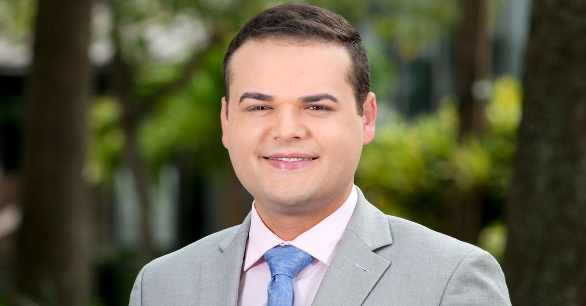 Dylan Lyons appears in a promotional photograph for Charter's Spectrum News 13 in Orlando, Florida. (Photo courtesy Charter/Spectrum News, Graphic by The Desk)