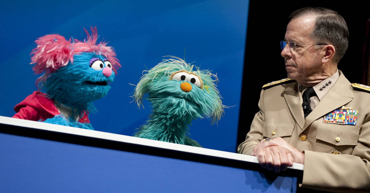 Chairman of the Joint Chiefs of Staff Adm. Mike Mullen speaks with Sesame Street Muppets Jesse and Rosita at a preview of the PBS special "When Families Grieve" in the Pentagon on April 13, 2010. The program portrays the tales of children coping with the loss of a parent and skills that have helped them move forward. 
