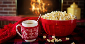 A stock image of popcorn and a hot holiday beverage.