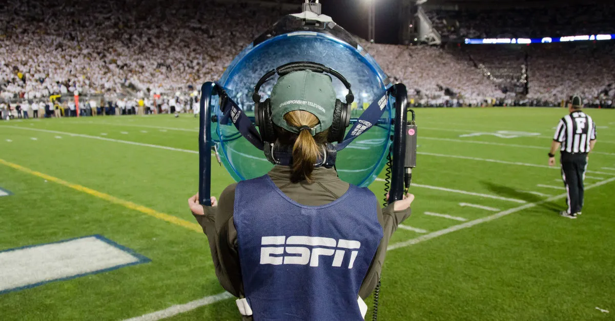 A sound technician with ESPN helps produce a telecast of a football game.