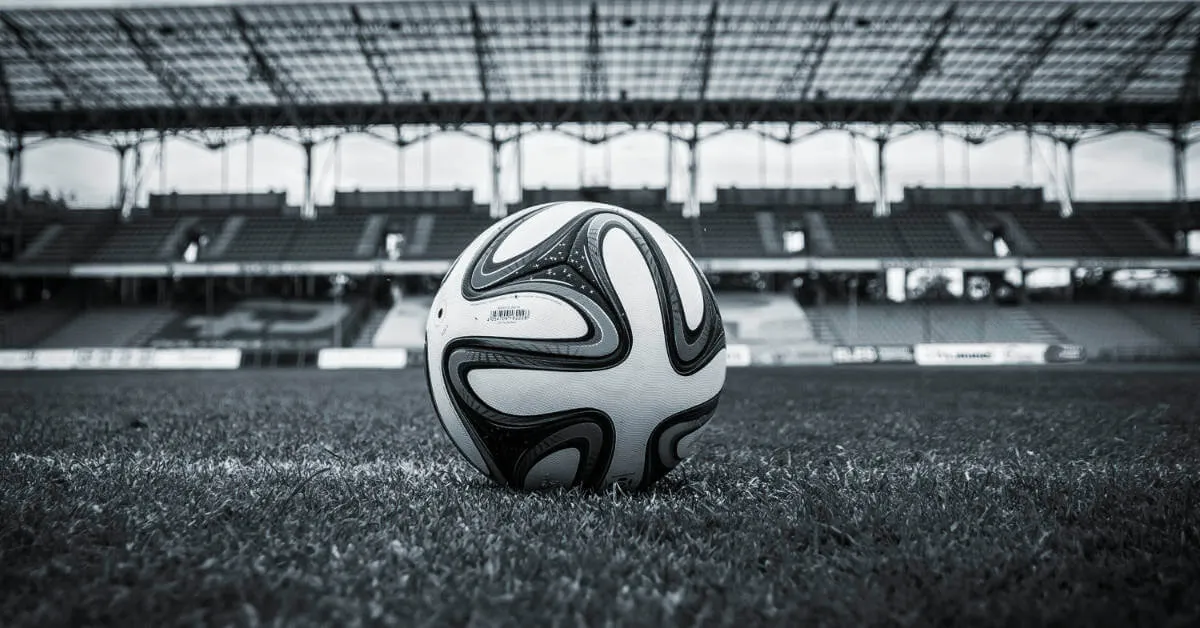 A soccer ball inside a stadium. (Stock image, Graphic by The Desk)