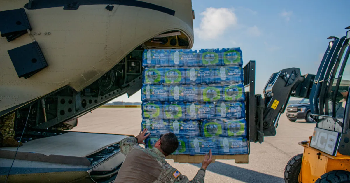U.S. Army aviators assigned to the Savannah-based Bravo Company, 1-169th Aviation Battalion, 78th Aviation Troop Command, Georgia Army National Guard, load pallets of water into a CH-47 Chinook helicopter, Sept. 30, 2024, at the Middle Georgia Regional Airport in Macon, Georgia. The Georgia National Guard is providing response and recovery support to areas impacted by Hurricane Helene. (Photo by Spc. Katlynn Pickle, U.S. Army National Guard)