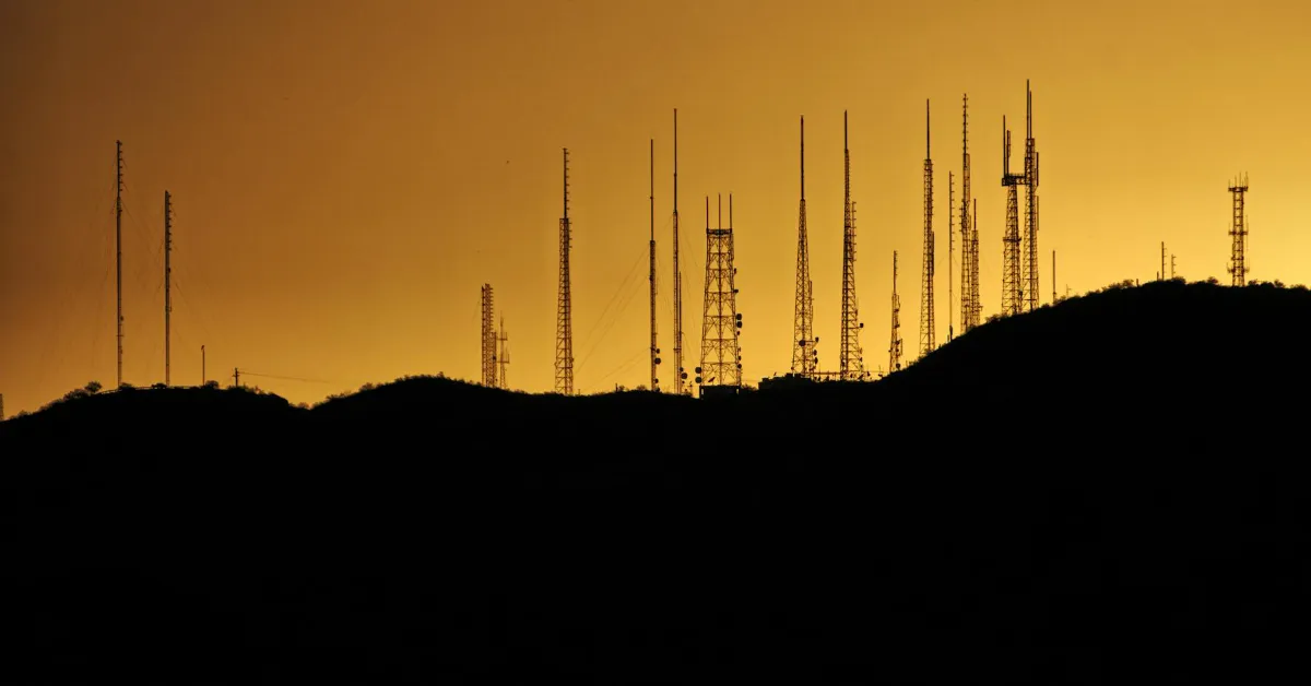 Communication towers against a sunset, or a sunrise, depending on how you look at it.