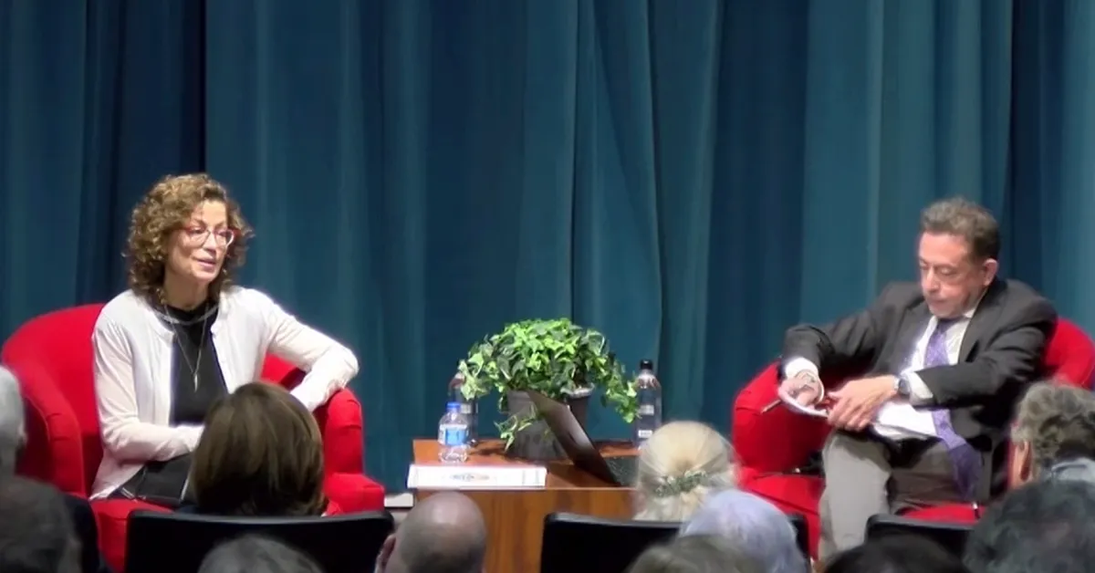 FCC Commissioner Anna Gomez (left) speaks with Steve Herman, the Executive Director of the Jordan Center at the University of Mississippi's School of Journalism. (Still frame via web broadcast, Graphic by The Desk)