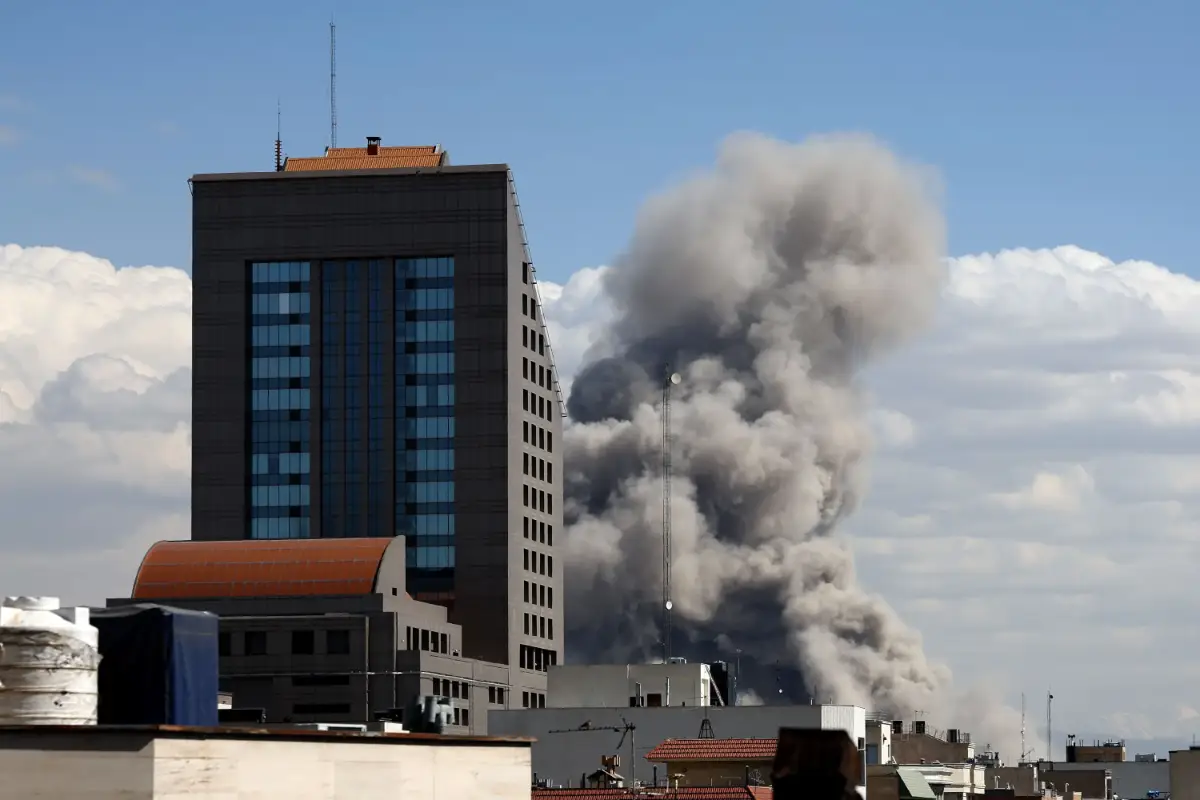 Smoke rises from a building in the Iranian capital Tehran following U.S. and Israeli missile strikes against targets there. (Photo by Avash Media)