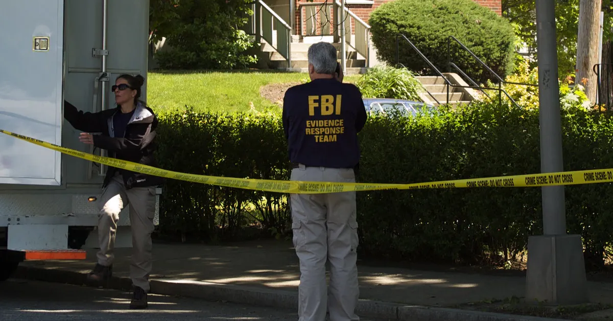 FBI agent collecting evidence.