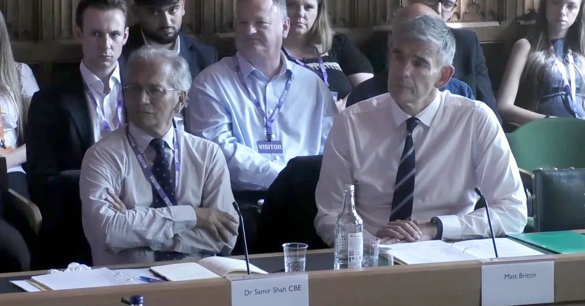BBC Director General Matt Brittin (right) participates in a hearing before the Culture, Media and Sports Committee. (Still frame via broadcast, Graphic by The Desk)