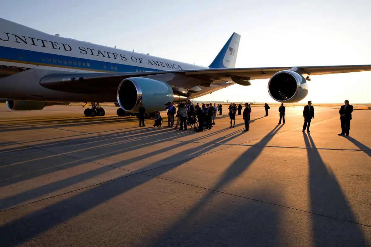 The press pool gathers under the wing of Air Force One, prior to President Barack Obama's departure from George Bush Intercontinental Airport, in Houston, Texas, Oct. 16, 2009. (Official White House Photo by Pete Souza)